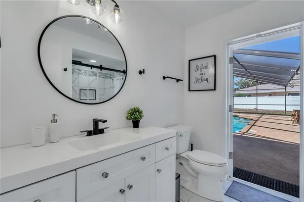 a bathroom with a toilet a sink and a mirror
