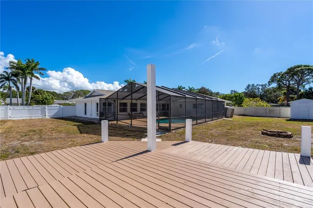a view of a house with swimming pool and sitting area