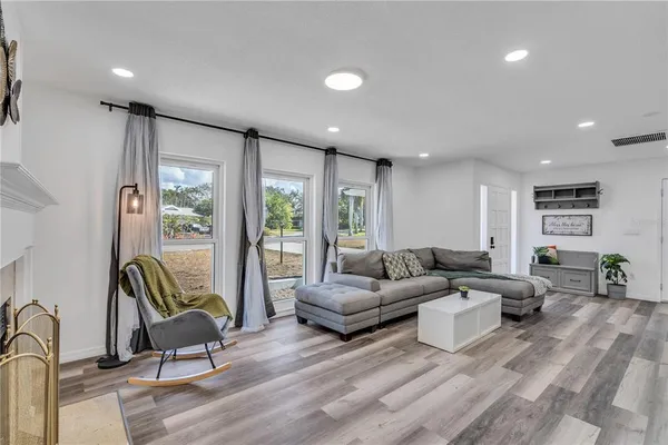 a living room with furniture and large windows