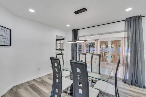a view of a dining room with furniture window and wooden floor