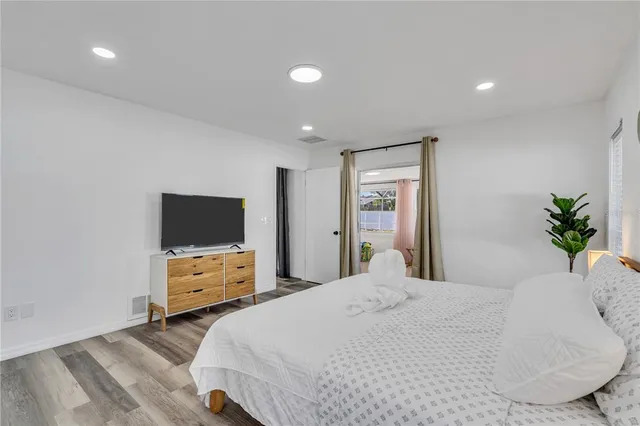 a bedroom with a bed and a flat screen tv