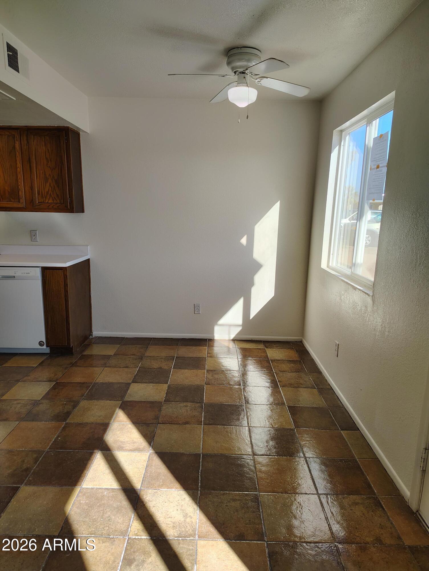 2560 South Yavapai Road Apache Junction, AZ 85119 - Photo 14 of 31 a view of an empty room with window and chandelier fan