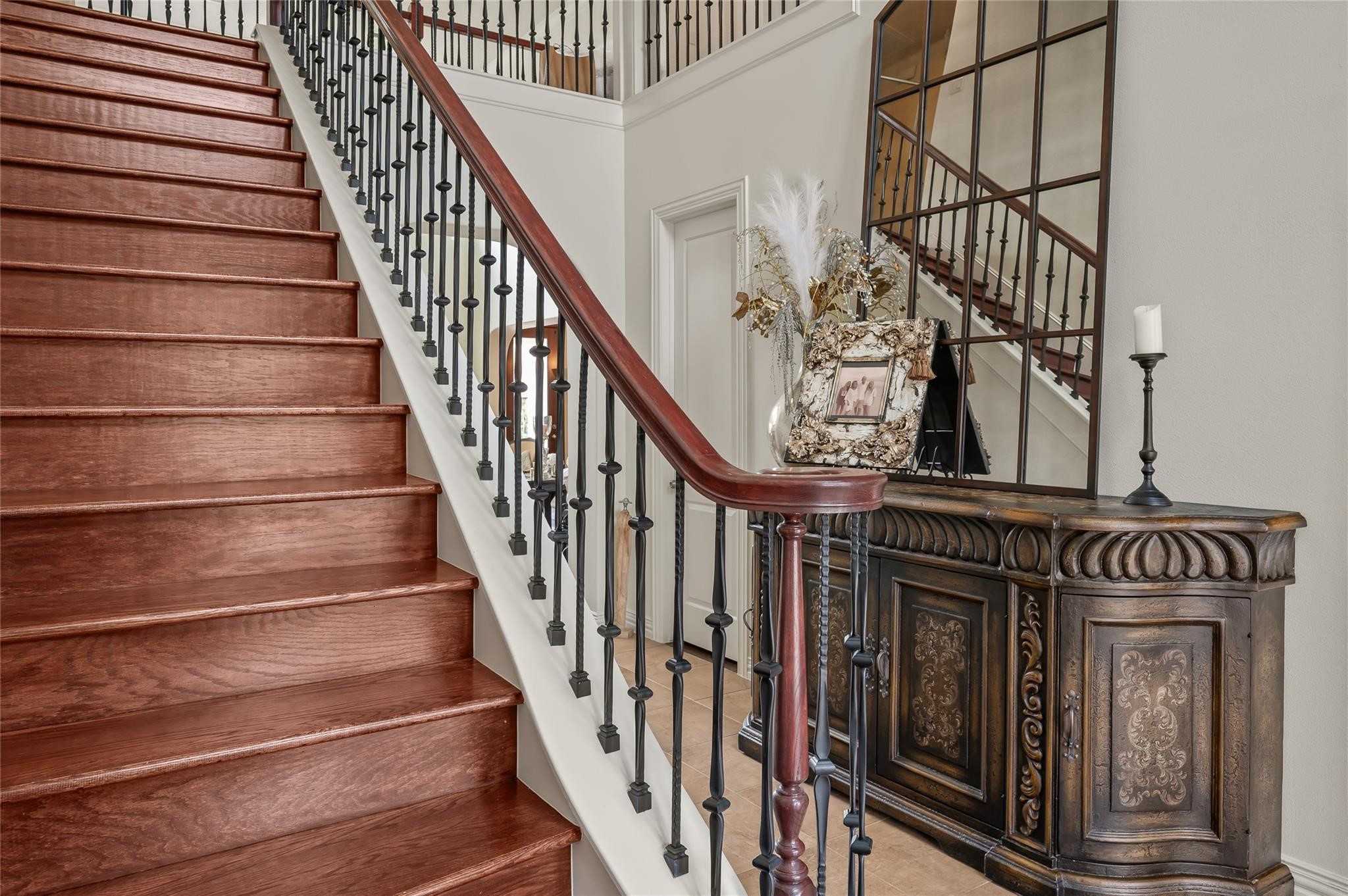 2127 Thicket Ridge Lane Houston, TX 77077 - Photo 10 of 50 The wood staircase leads from the foyer to 3 upstairs bedrooms, two baths and a separate enclosed game room.