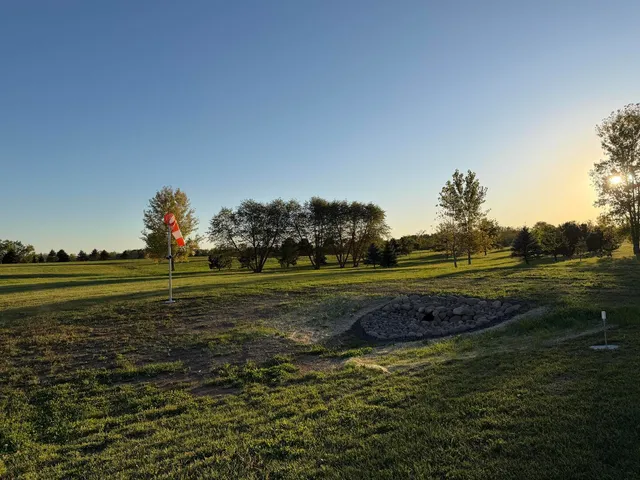 a view of a golf course with a lake view