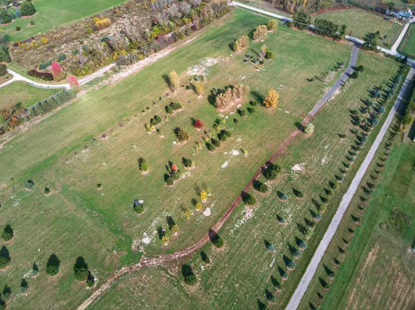 an aerial view of a residential houses with outdoor space