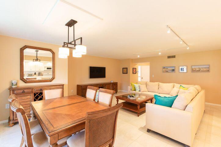 110 Half Moon Circle, Unit E2 Hypoluxo, FL 33462 - Photo 11 of 14 a living room with furniture and a flat screen tv