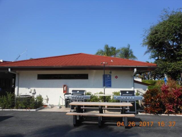 110 Half Moon Circle, Unit E2 Hypoluxo, FL 33462 - Photo 7 of 14 a view of house with outdoor space and porch