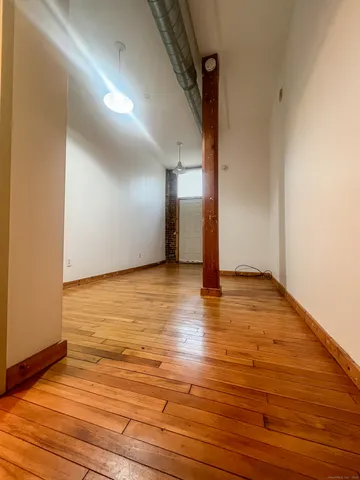 a view of a room with wooden floor