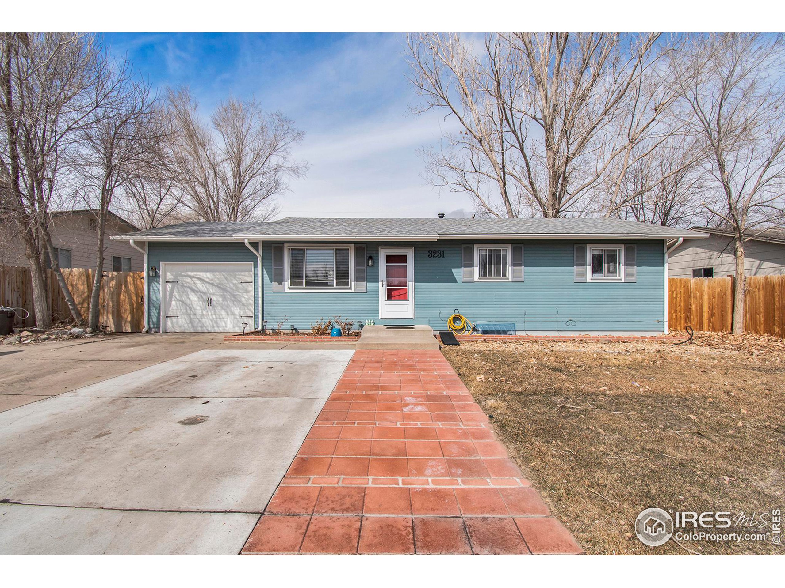 3231 West 5th St Road Greeley, CO 80634 - Photo 1 of 31 a front view of a house with a yard