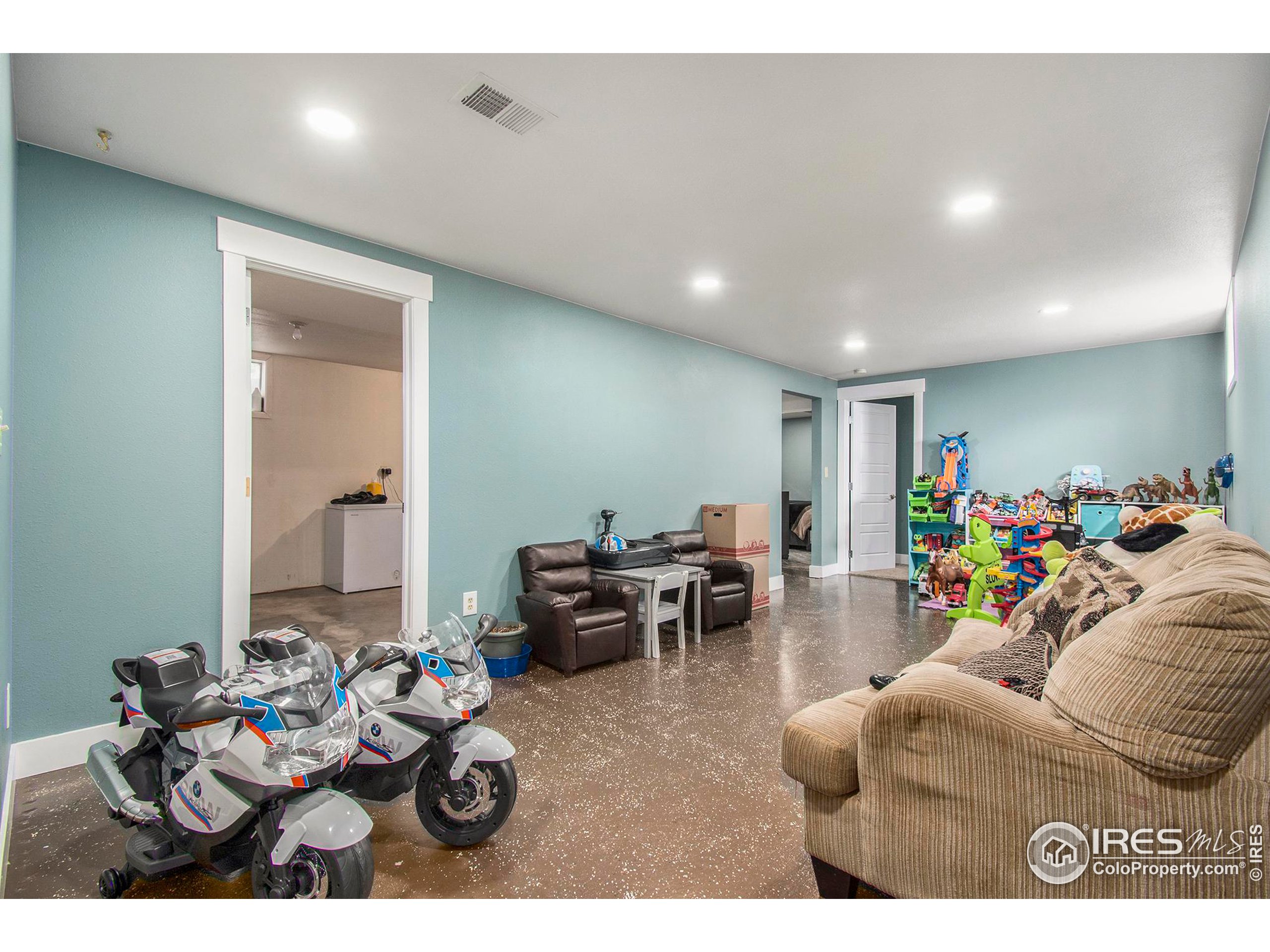 3231 West 5th St Road Greeley, CO 80634 - Photo 22 of 31 a living room with furniture and a table