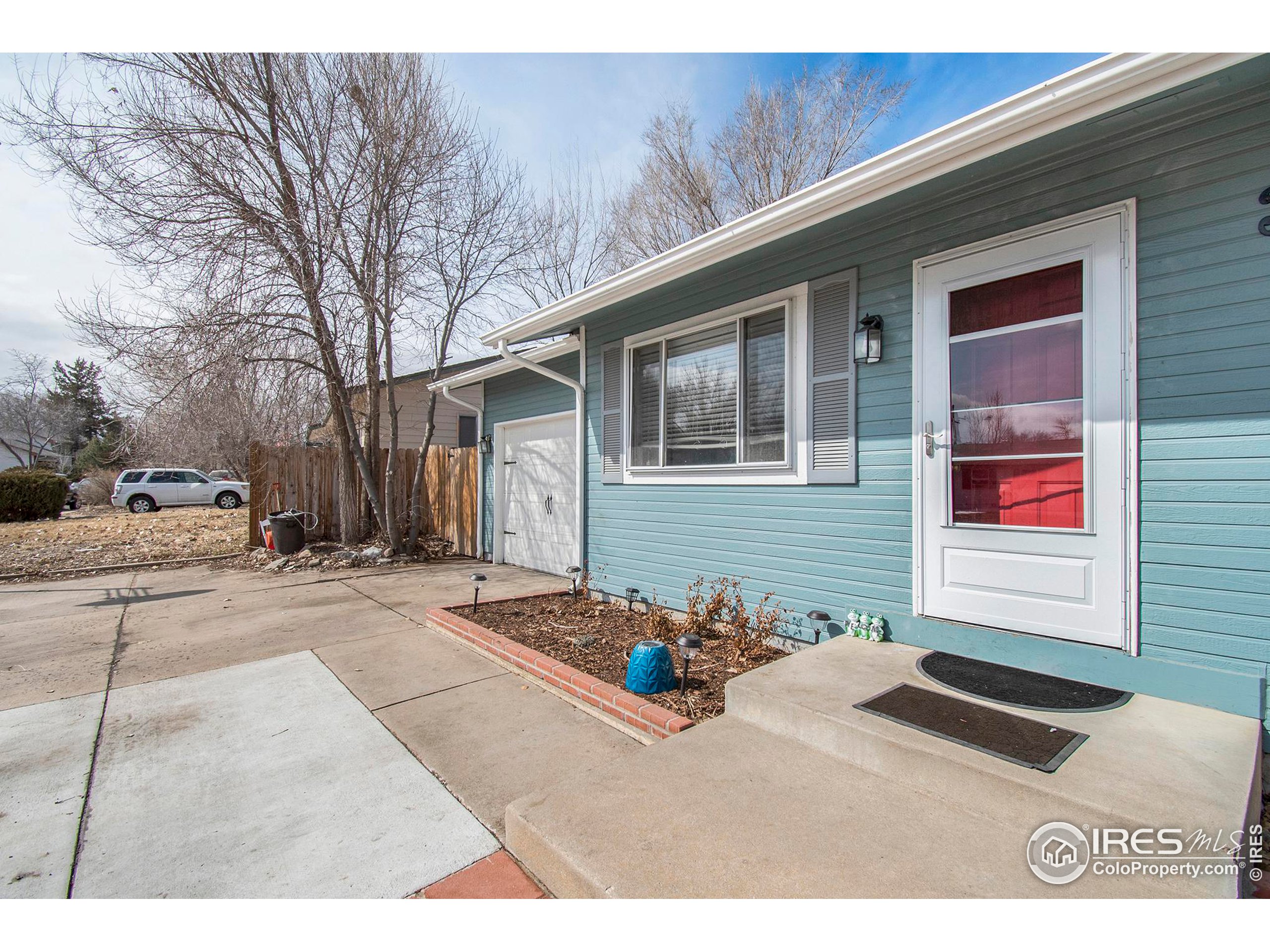 3231 West 5th St Road Greeley, CO 80634 - Photo 4 of 31 a backyard of a house with potted plants and trees