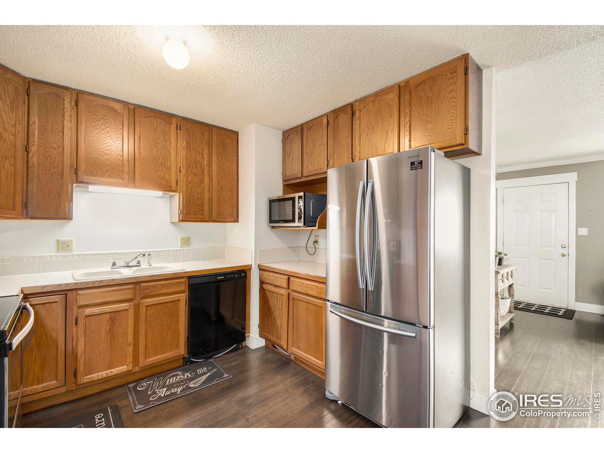 3231 West 5th St Road Greeley, CO 80634 - Photo 8 of 31 a kitchen with stainless steel appliances a refrigerator sink and cabinets
