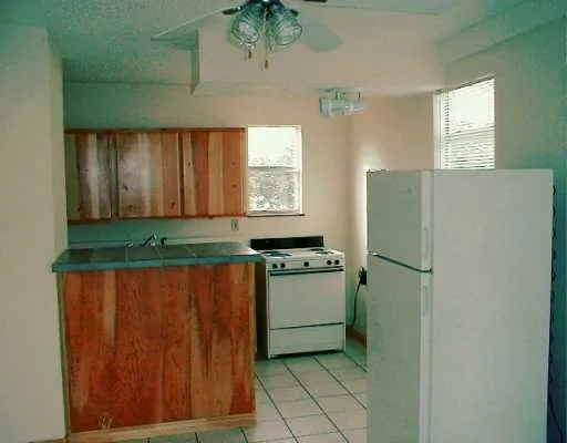 a kitchen with a refrigerator and window