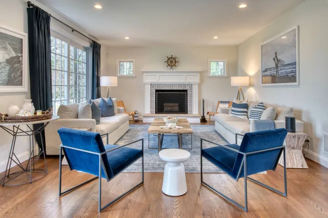 a living room with furniture a fireplace and a table