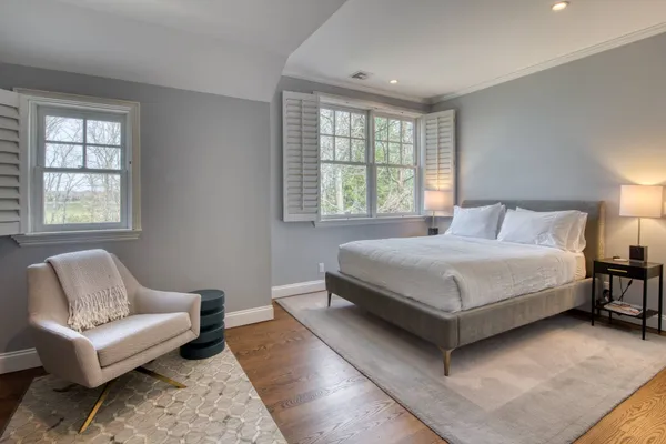 a bedroom with a bed couch and window