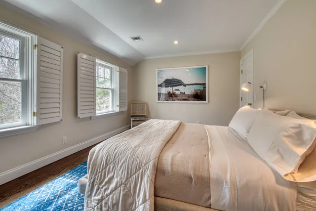 a bedroom with bed and a window