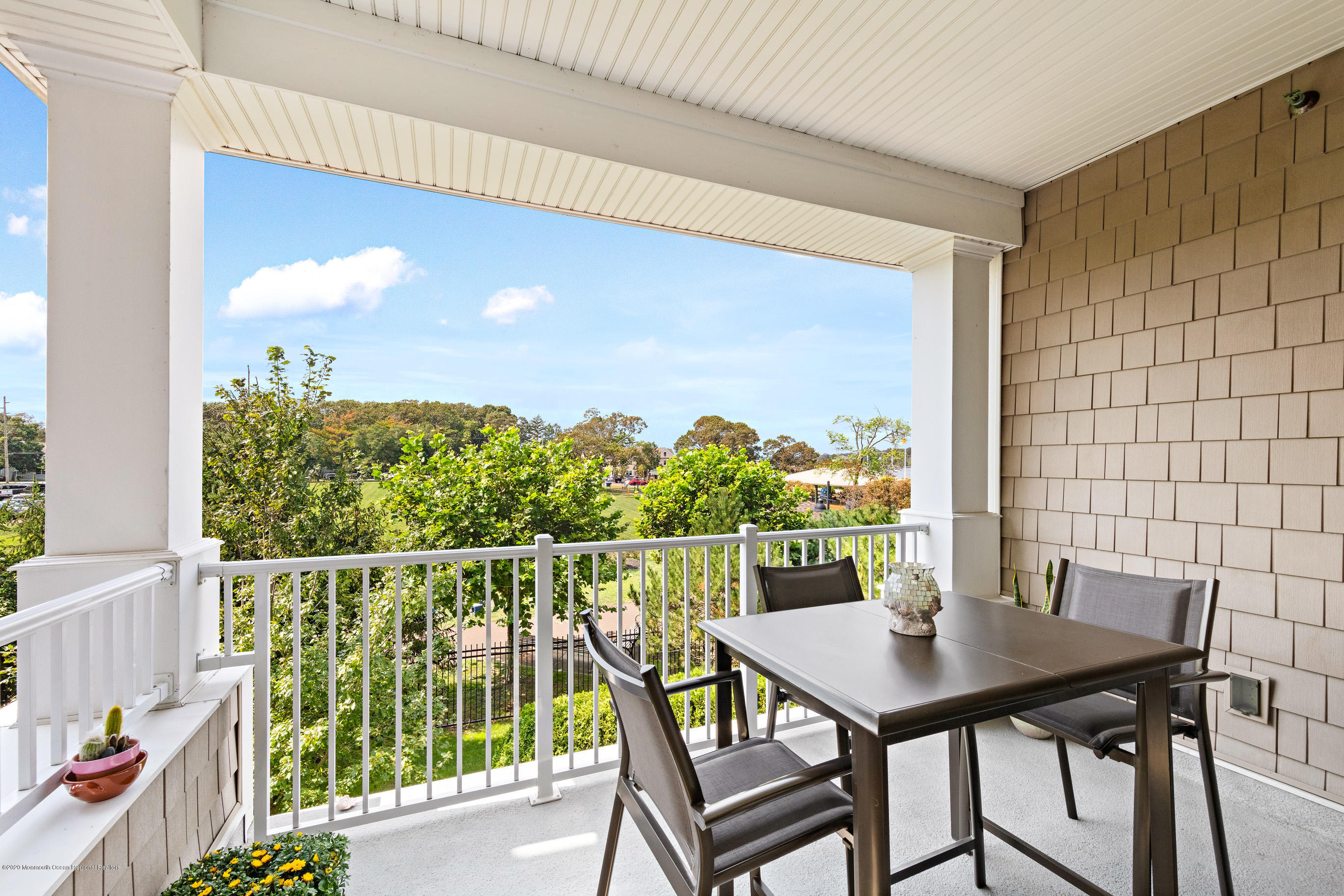 2201 River Road, Unit 1203 Point Pleasant, NJ 08742 - Photo 11 of 51 a view of a balcony with table and chairs