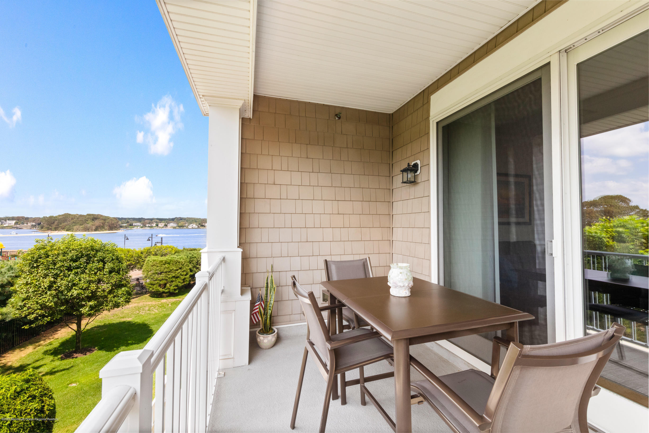 2201 River Road, Unit 1203 Point Pleasant, NJ 08742 - Photo 12 of 51 a balcony with table and chairs
