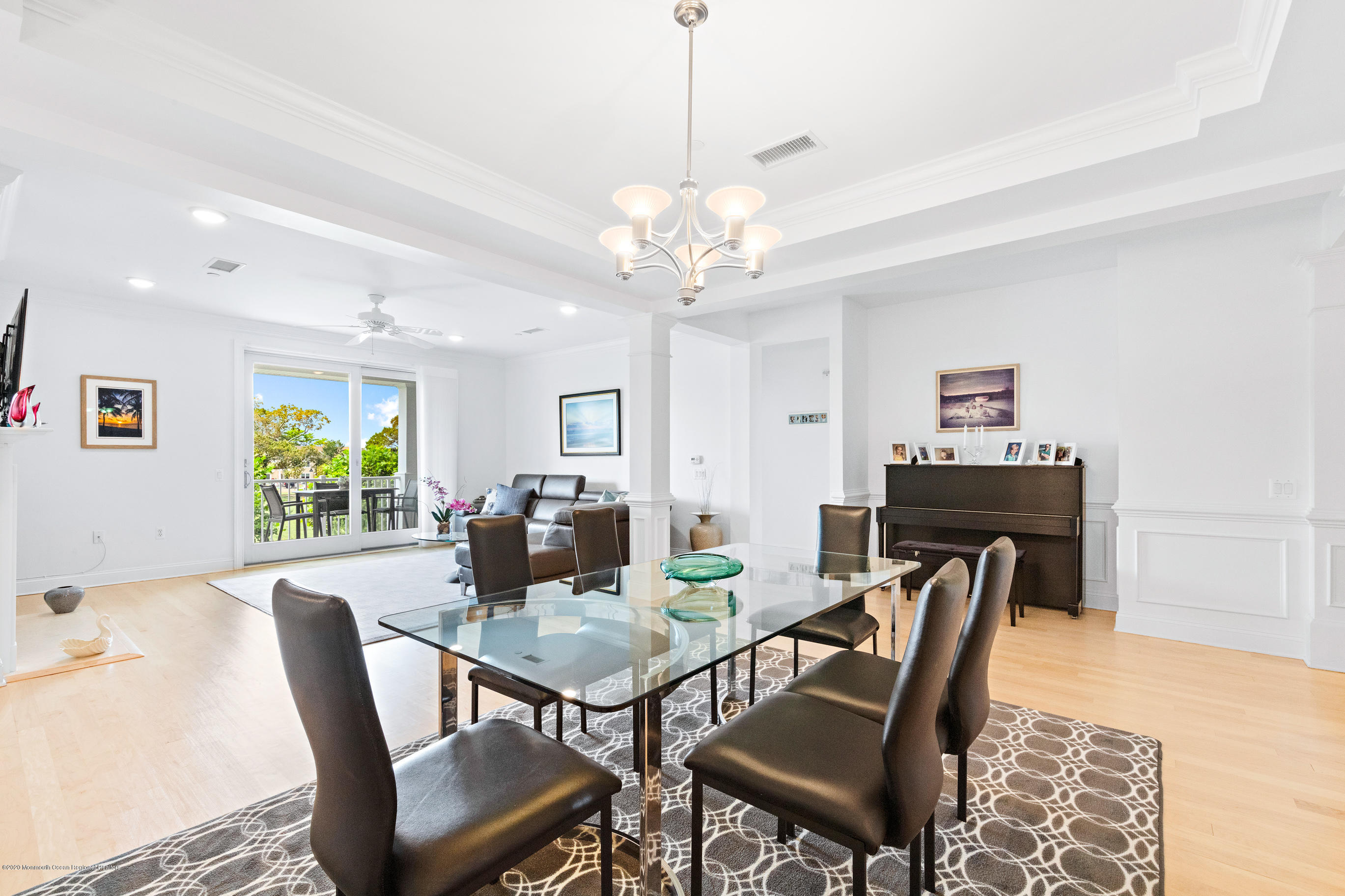 2201 River Road, Unit 1203 Point Pleasant, NJ 08742 - Photo 15 of 51 a view of a dining room with furniture and a chandelier