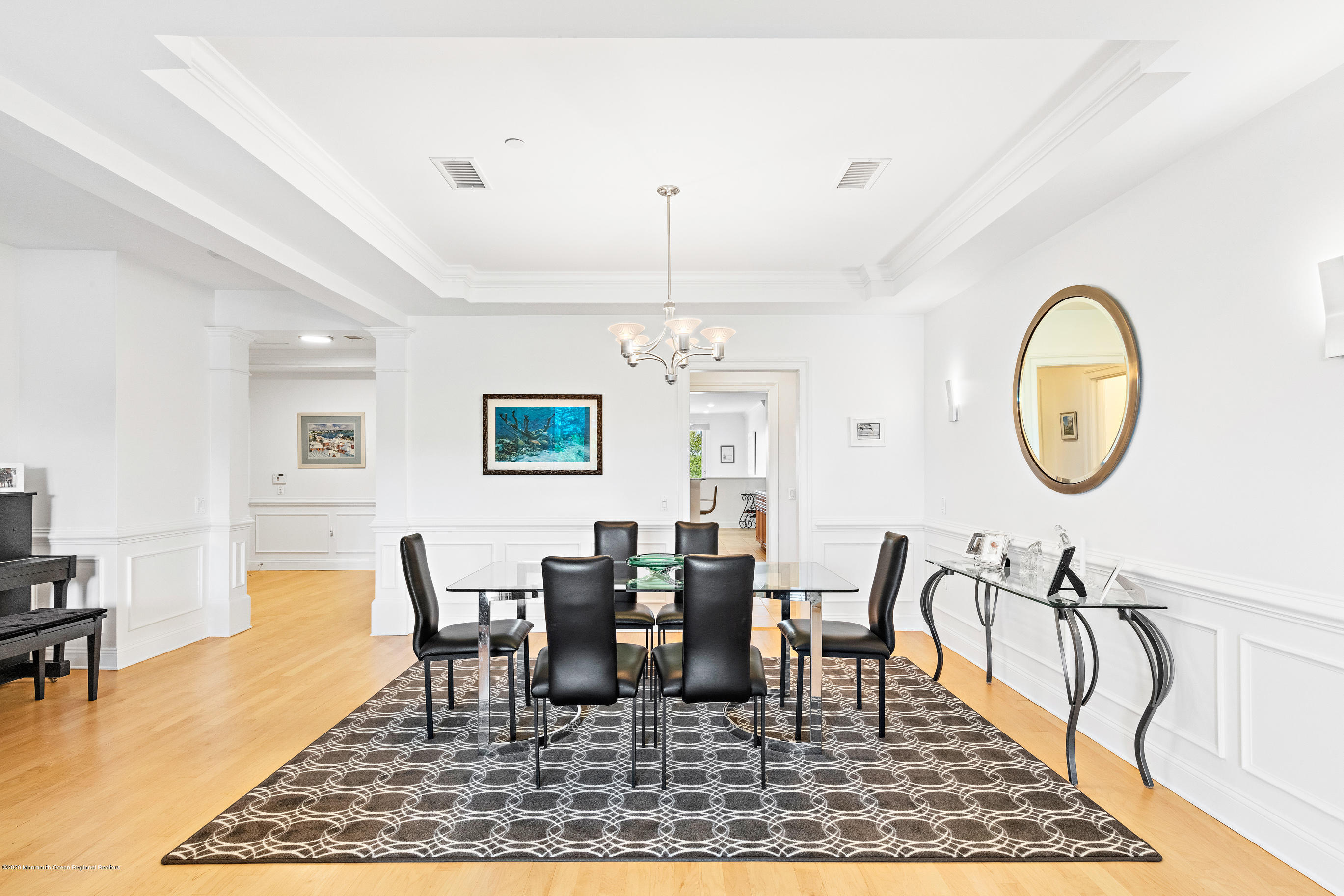 2201 River Road, Unit 1203 Point Pleasant, NJ 08742 - Photo 17 of 51 a dining room with wooden floor a chandelier a wooden table and chairs