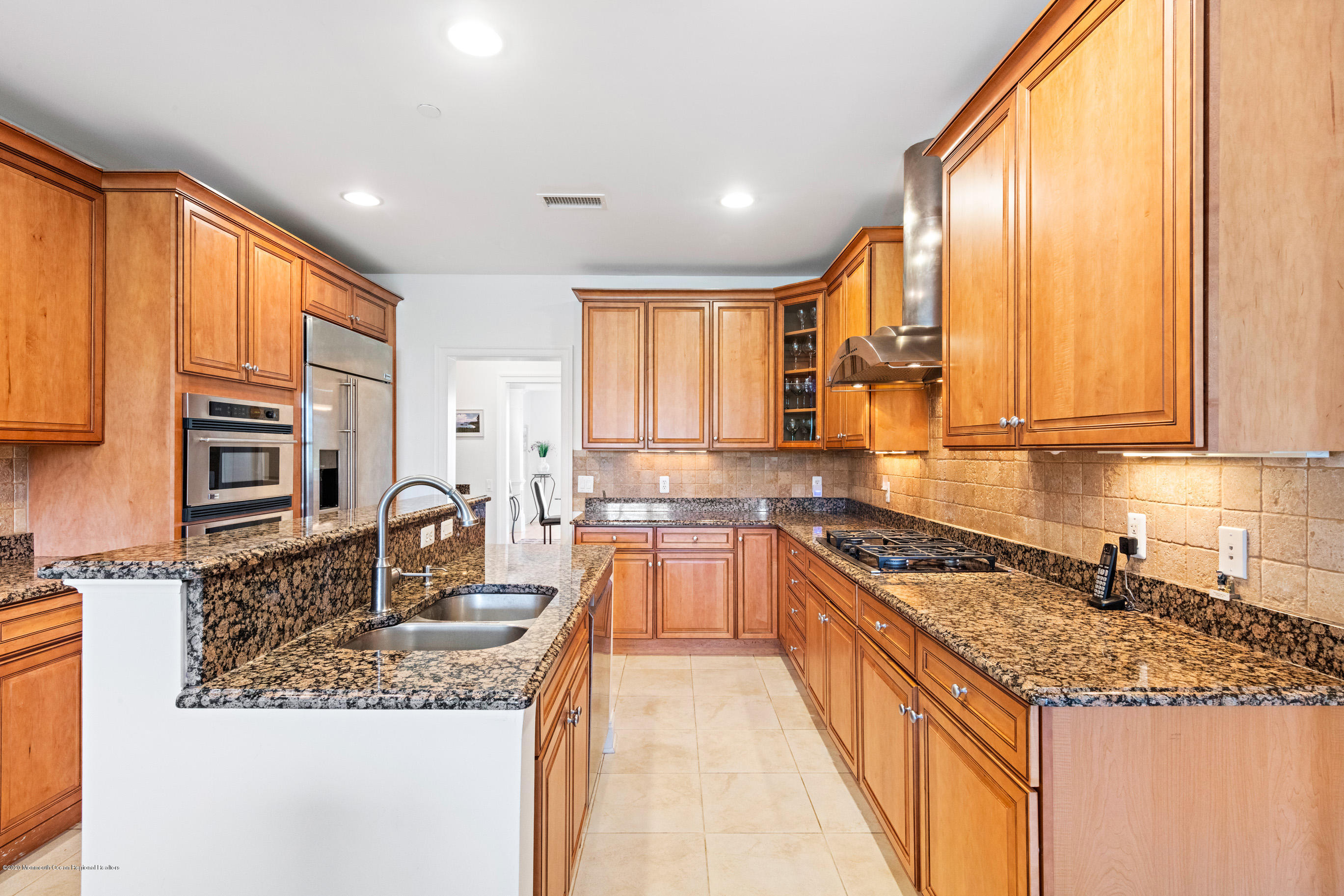 2201 River Road, Unit 1203 Point Pleasant, NJ 08742 - Photo 21 of 51 a kitchen with granite countertop a sink a counter top space and stainless steel appliances