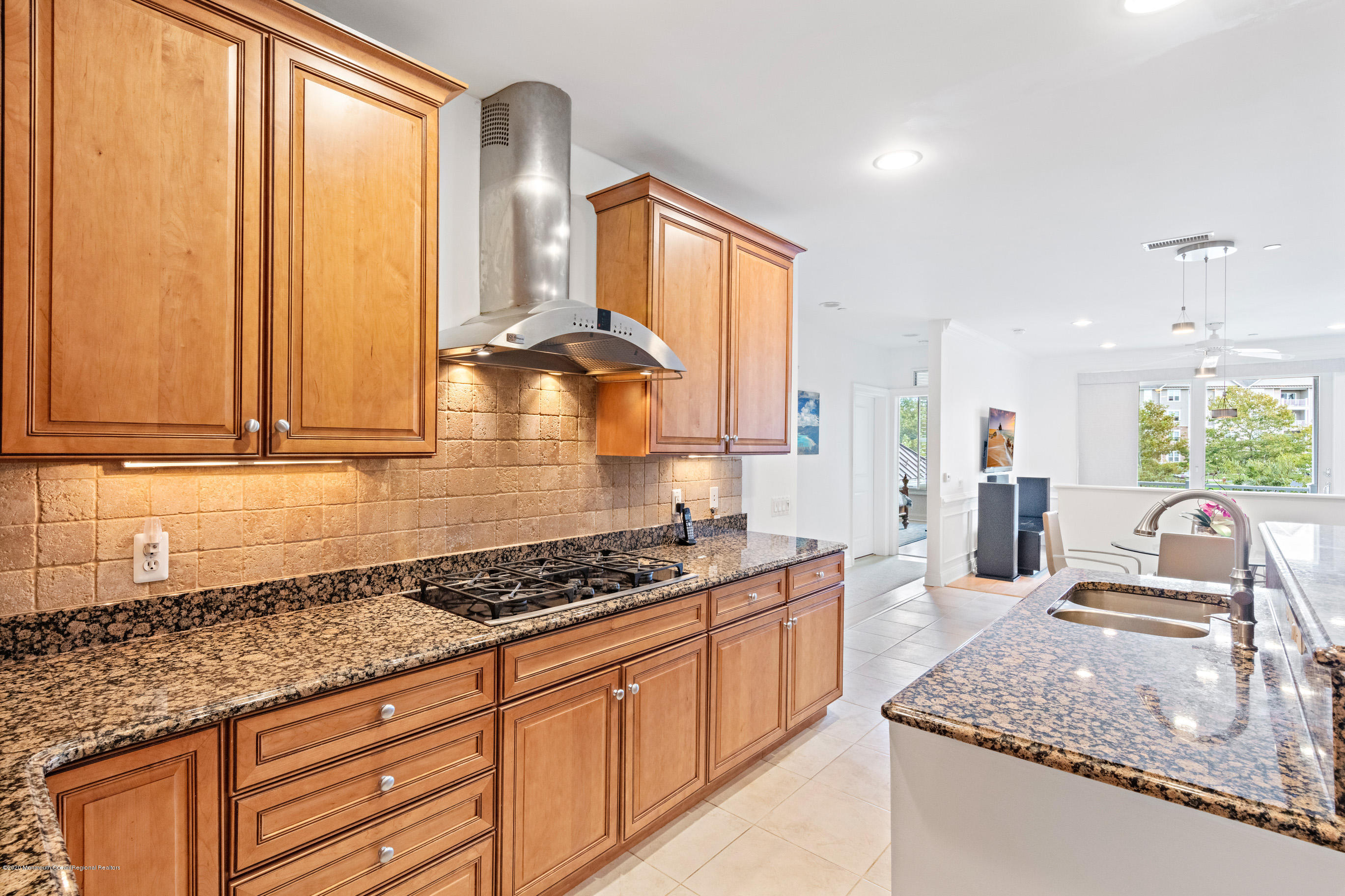 2201 River Road, Unit 1203 Point Pleasant, NJ 08742 - Photo 23 of 51 a kitchen with stainless steel appliances granite countertop a sink stove and cabinets