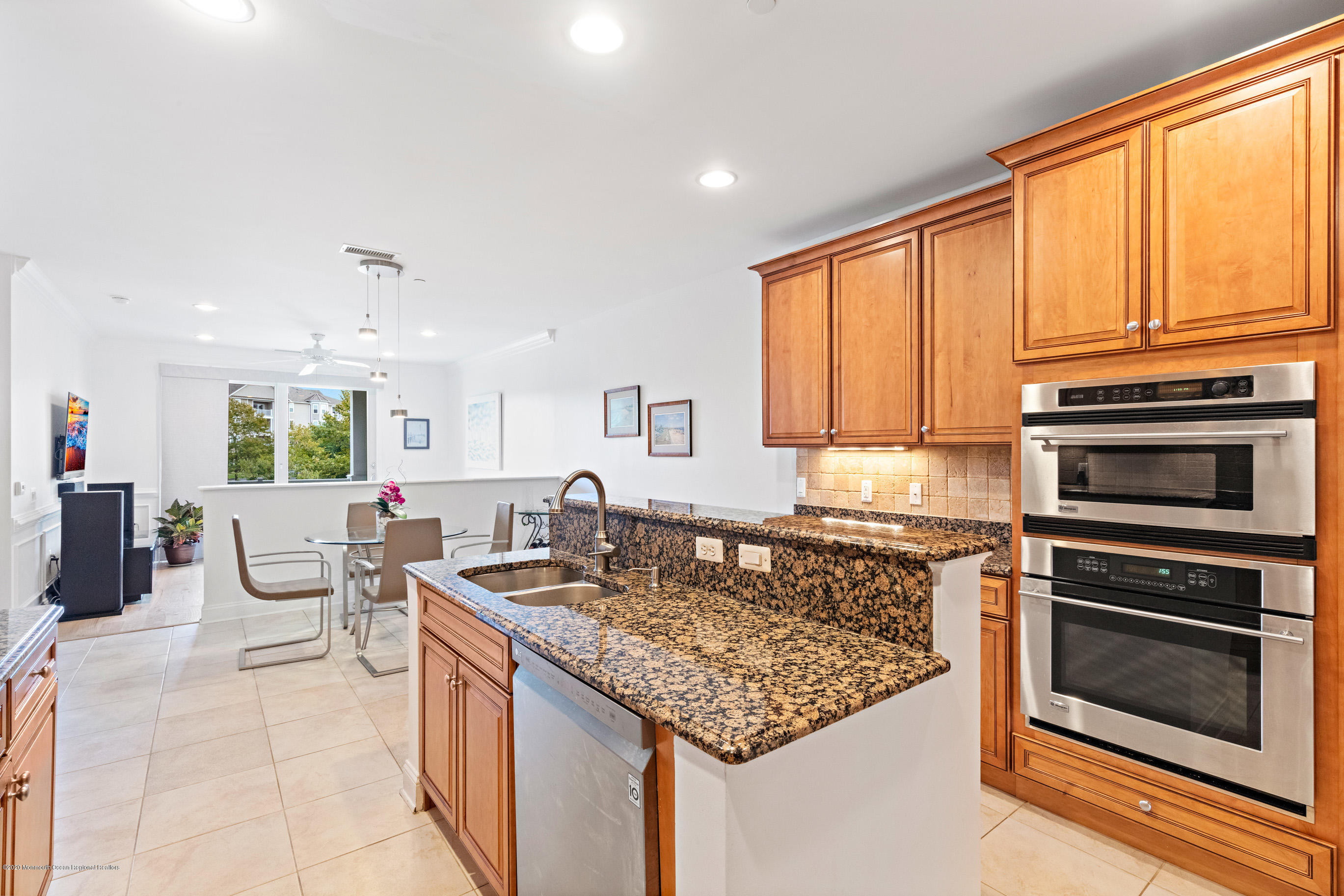 2201 River Road, Unit 1203 Point Pleasant, NJ 08742 - Photo 24 of 51 a kitchen with stainless steel appliances granite countertop a stove a sink and a microwave
