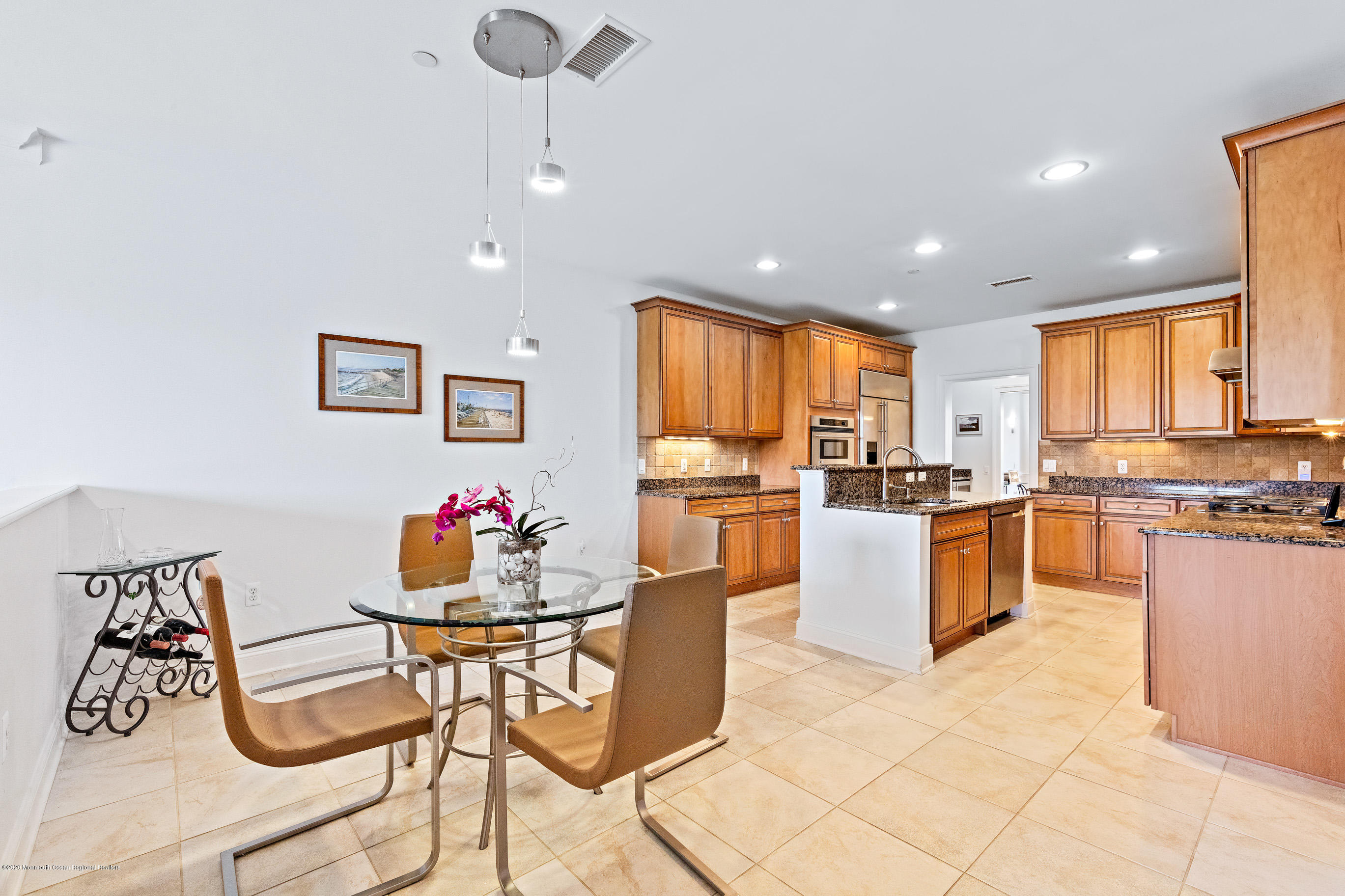 2201 River Road, Unit 1203 Point Pleasant, NJ 08742 - Photo 25 of 51 a kitchen with granite countertop a stove a sink a dining table and chairs