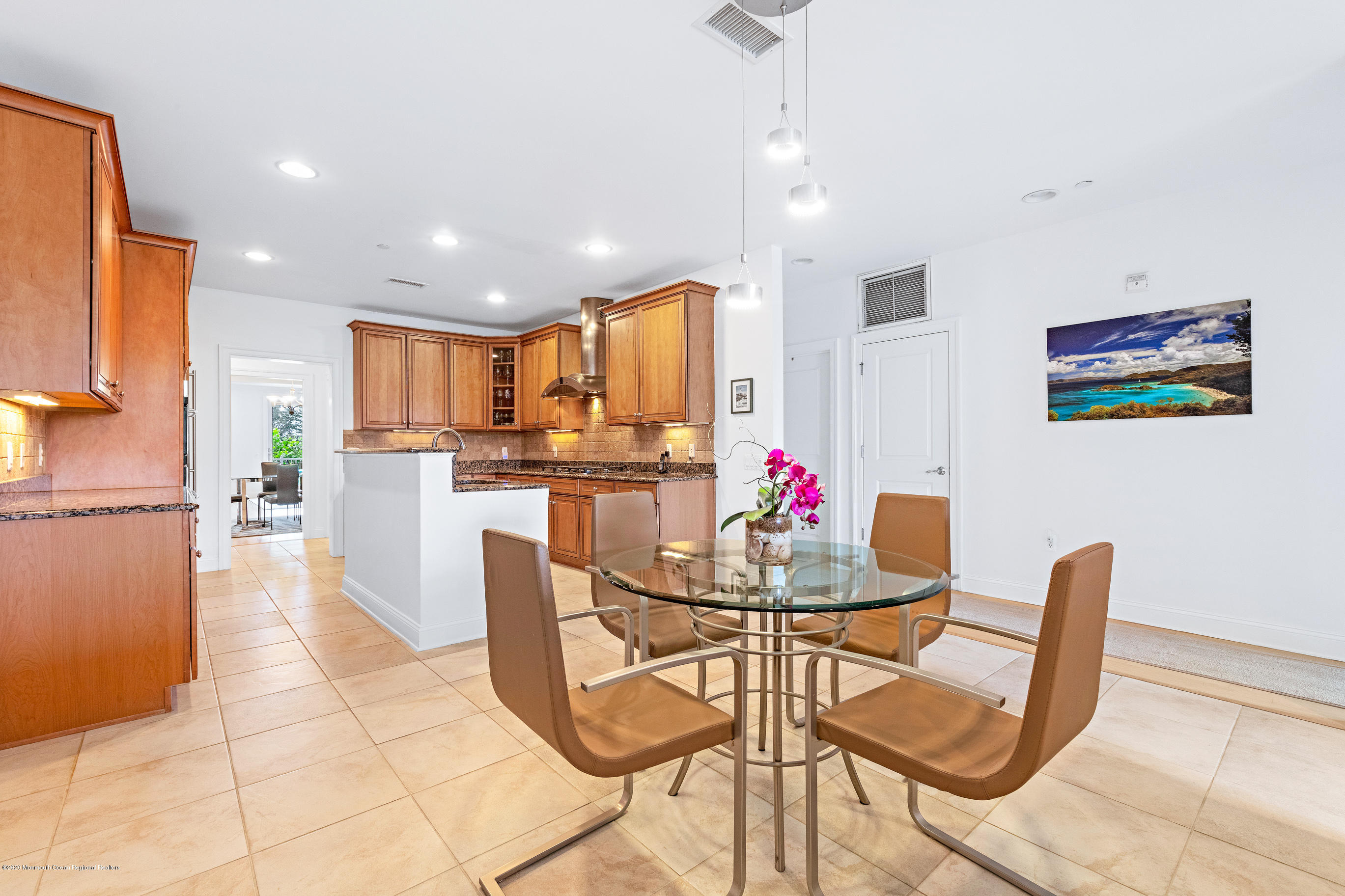 2201 River Road, Unit 1203 Point Pleasant, NJ 08742 - Photo 26 of 51 a dining room filled chandelier and kitchen view