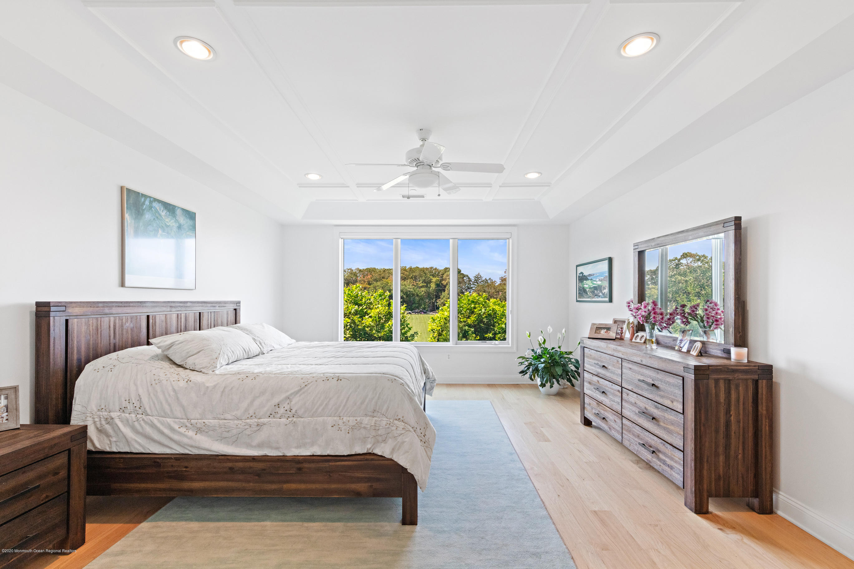 2201 River Road, Unit 1203 Point Pleasant, NJ 08742 - Photo 35 of 51 a spacious bedroom with a large bed and a chandelier