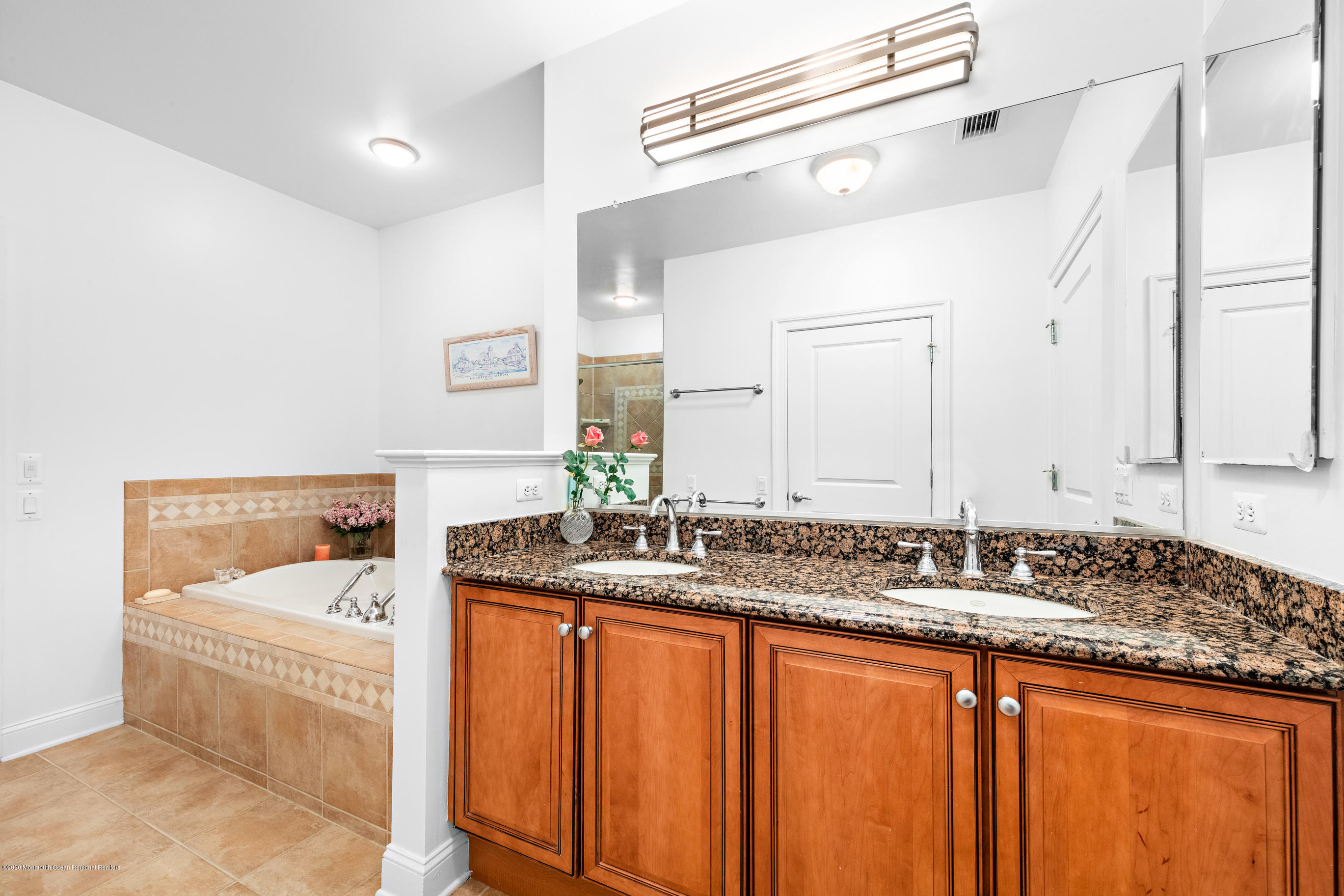 2201 River Road, Unit 1203 Point Pleasant, NJ 08742 - Photo 37 of 51 a bathroom with a granite countertop sink and a mirror