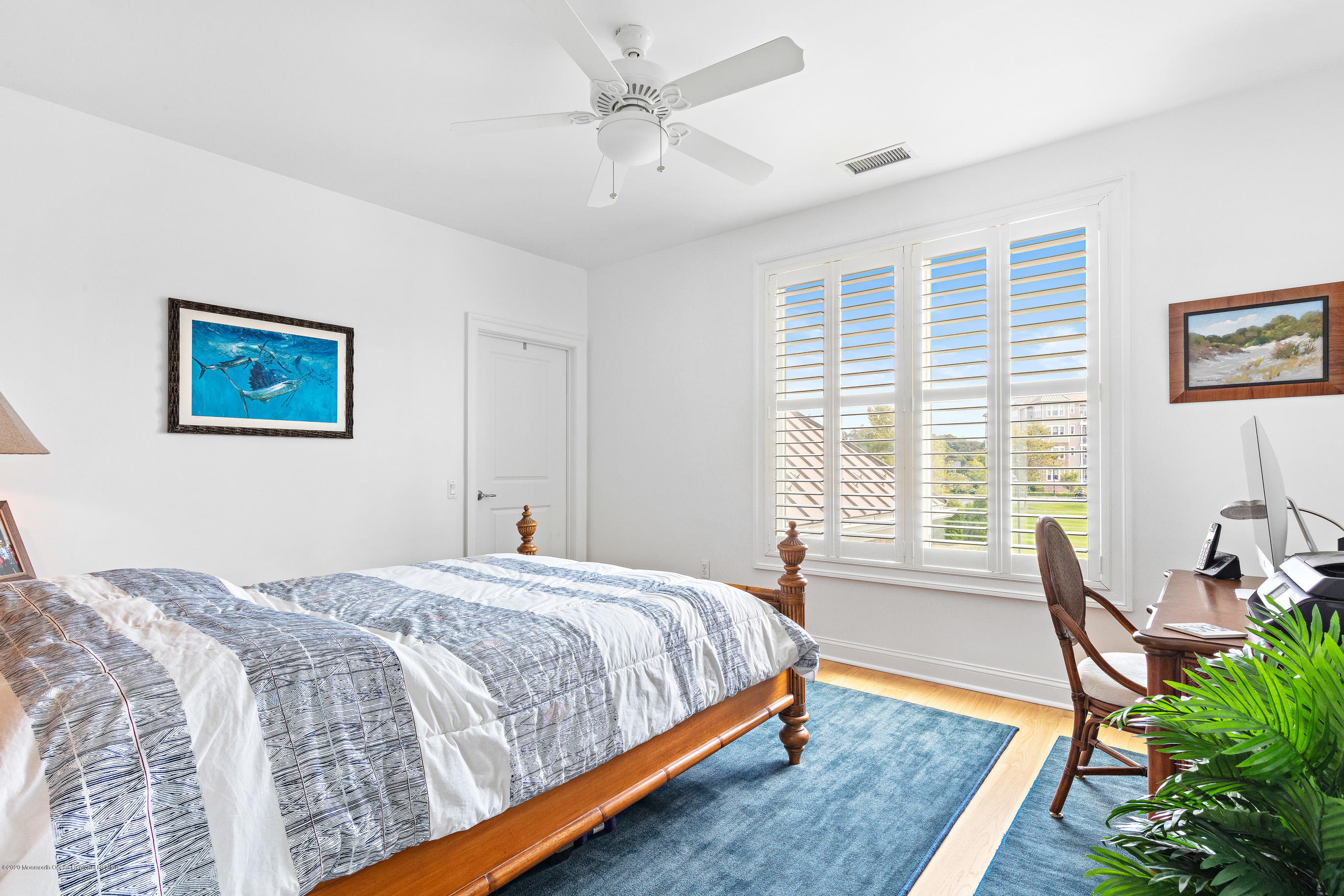 2201 River Road, Unit 1203 Point Pleasant, NJ 08742 - Photo 40 of 51 a bedroom with a bed a couch and a potted plant