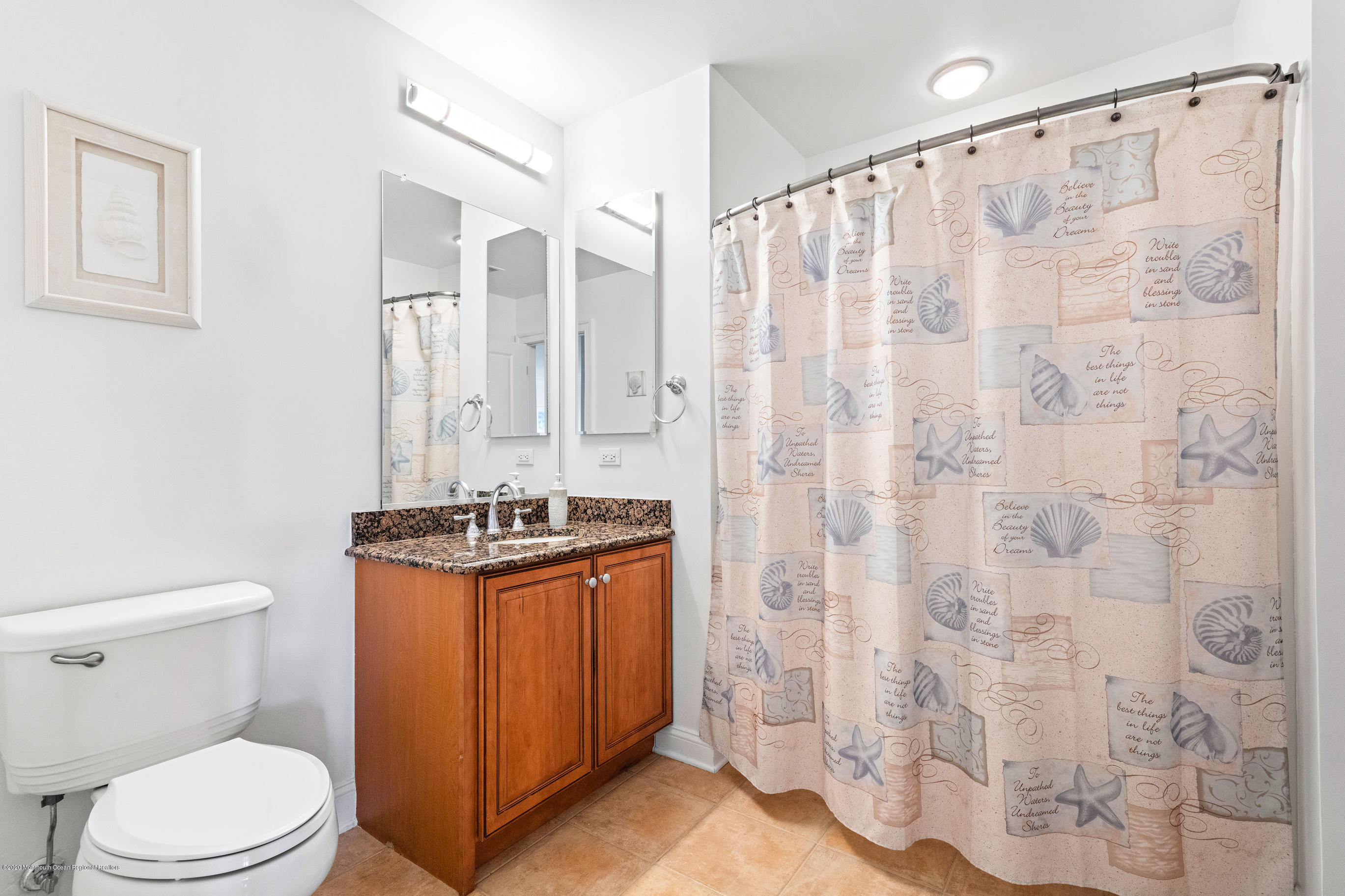 2201 River Road, Unit 1203 Point Pleasant, NJ 08742 - Photo 42 of 51 a bathroom with a granite countertop bathtub shower sink mirror and toilet