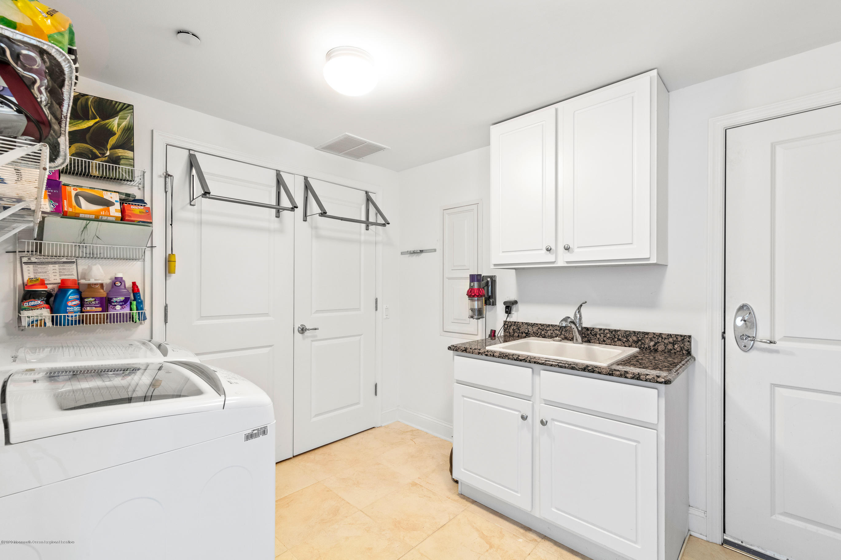 2201 River Road, Unit 1203 Point Pleasant, NJ 08742 - Photo 43 of 51 a utility room with cabinets washer and dryer