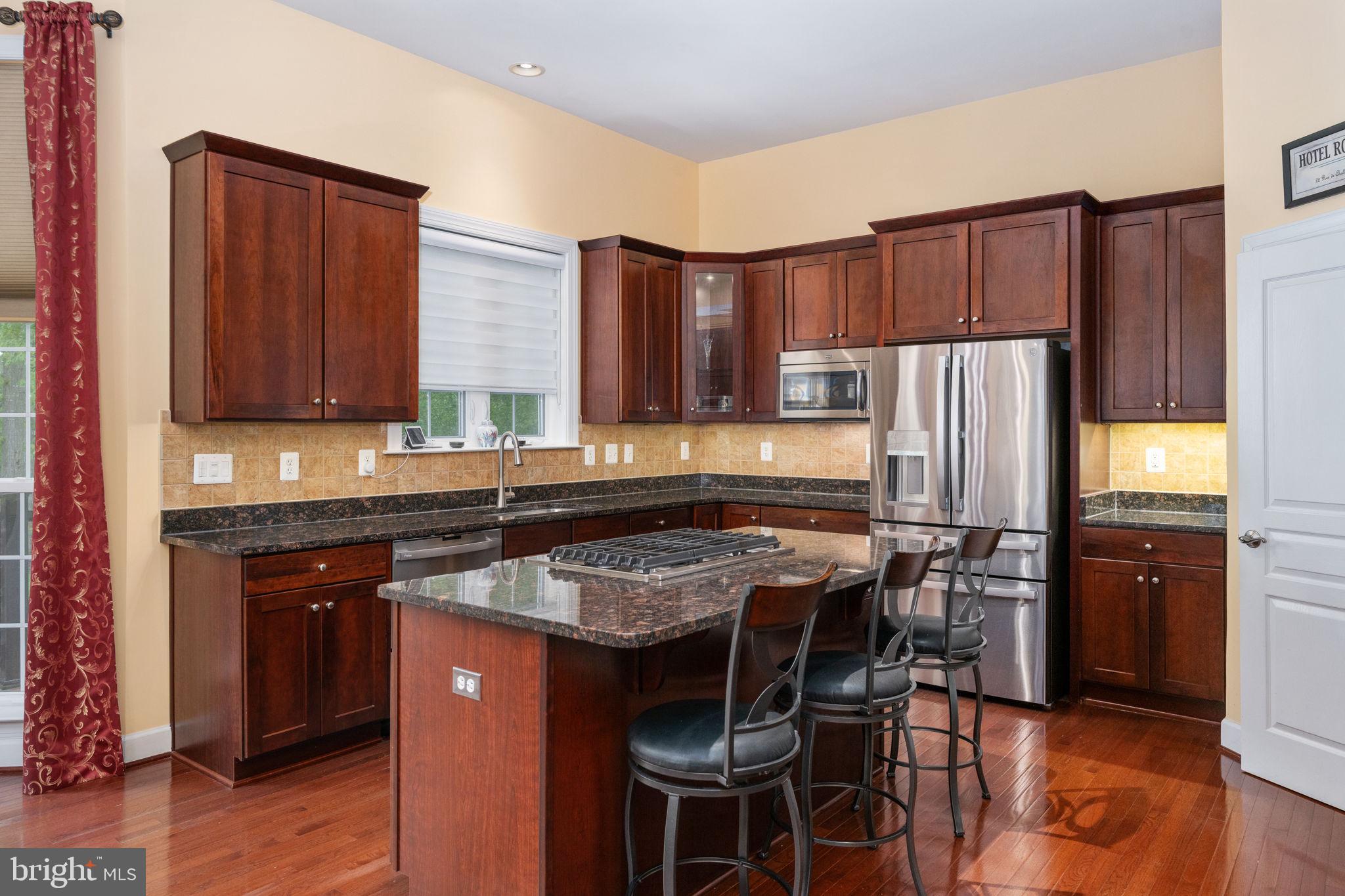14541 Old Mill Road Centreville, VA 20121 - Photo 33 of 109 Elegant kitchen with rich wood tones.
