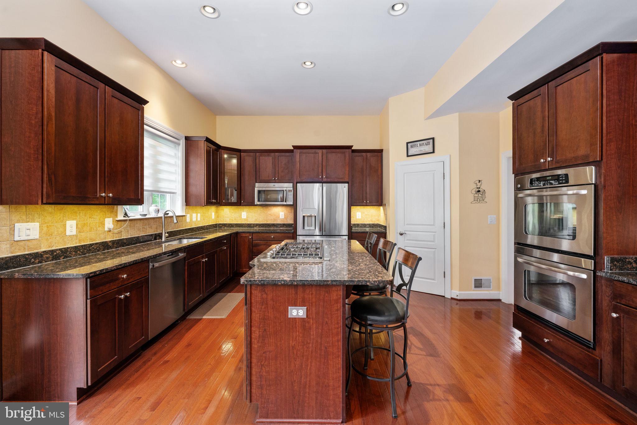 14541 Old Mill Road Centreville, VA 20121 - Photo 34 of 109 Modern kitchen with rich wood tones.