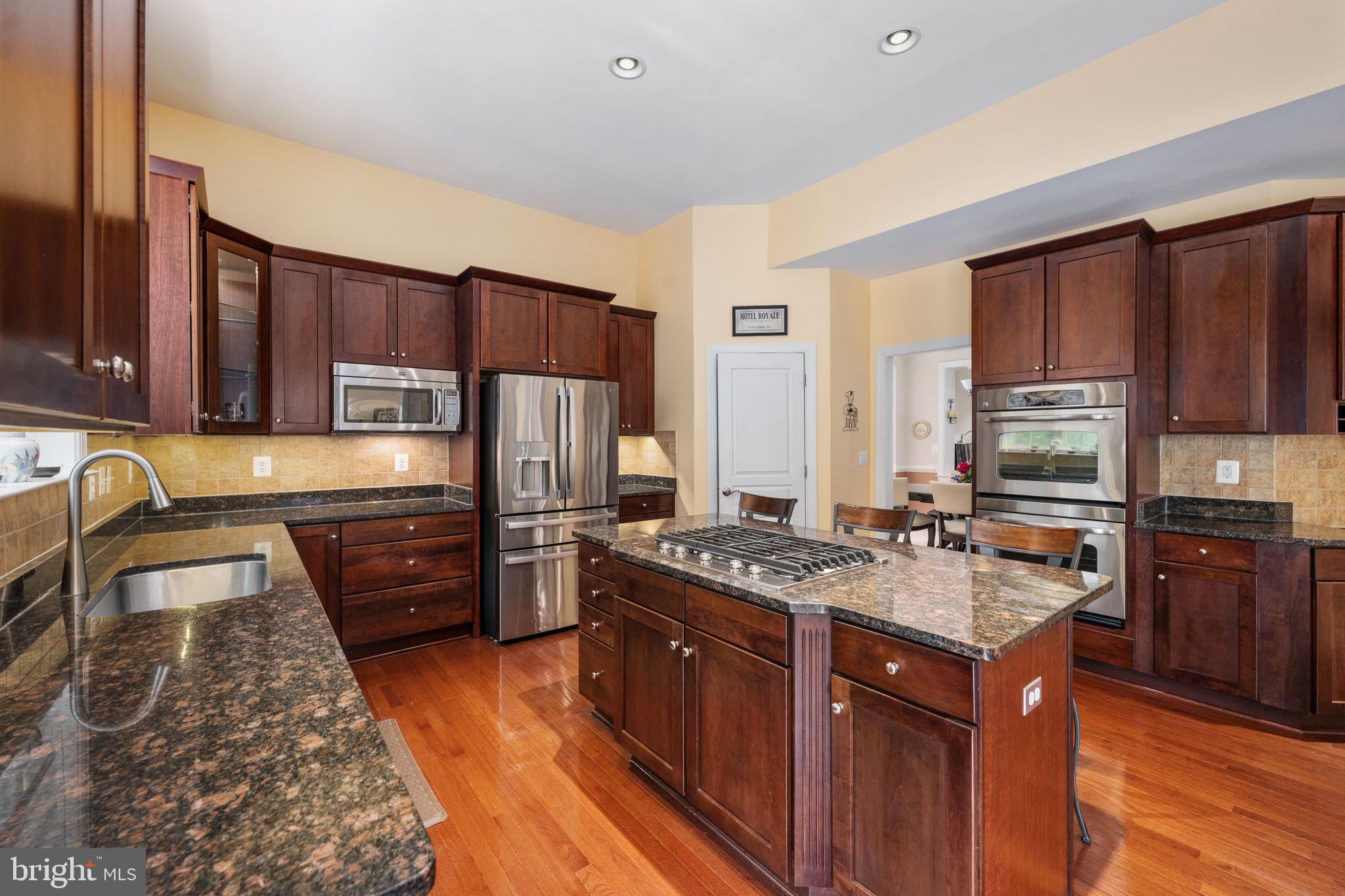 14541 Old Mill Road Centreville, VA 20121 - Photo 35 of 109 Elegant kitchen with rich wood tones.