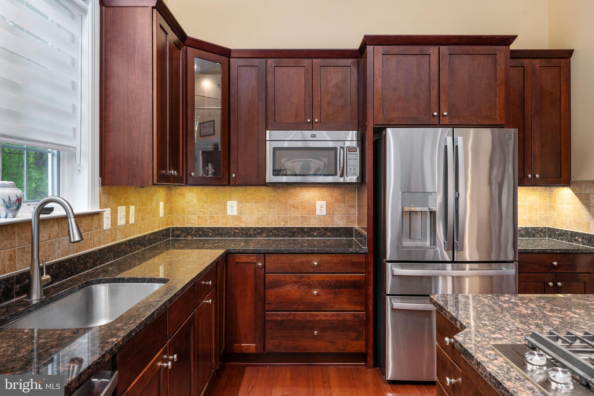 14541 Old Mill Road Centreville, VA 20121 - Photo 37 of 109 Elegant kitchen with rich wood tones.