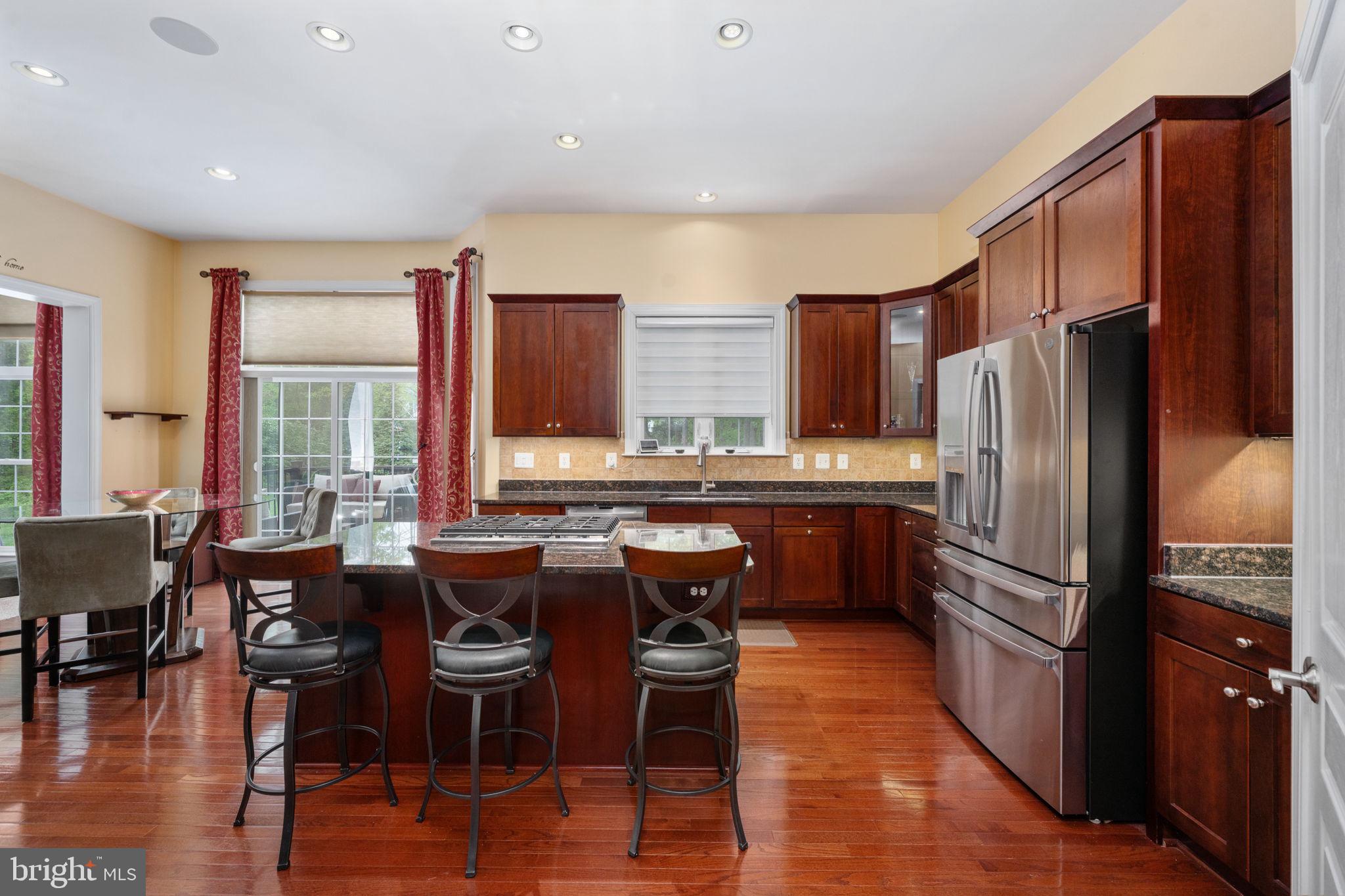 14541 Old Mill Road Centreville, VA 20121 - Photo 39 of 109 Elegant kitchen with rich wood tones.