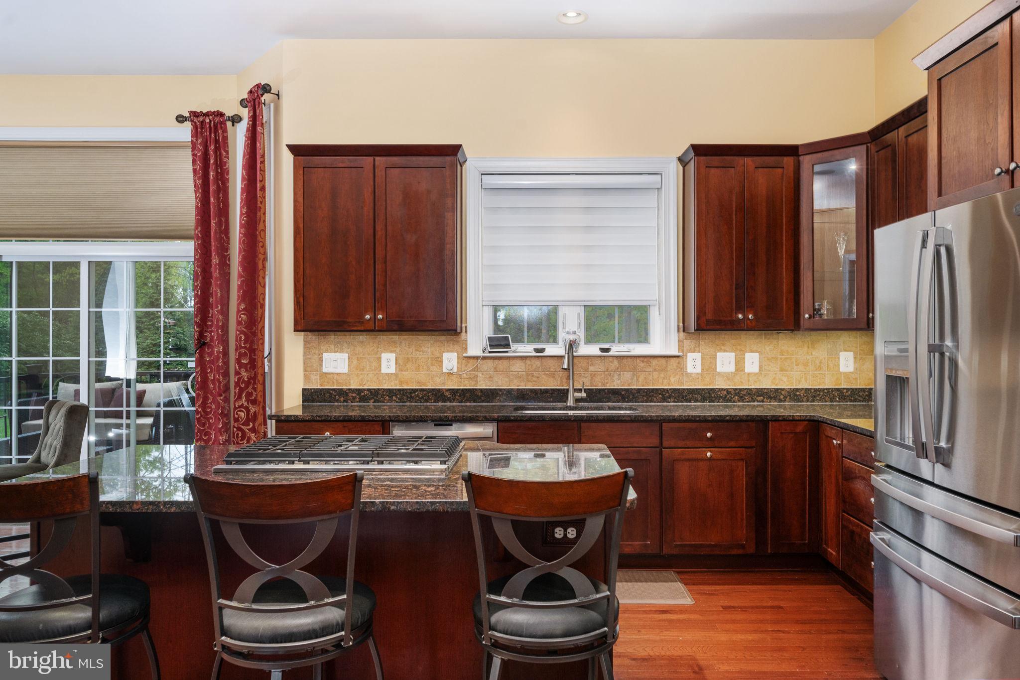 14541 Old Mill Road Centreville, VA 20121 - Photo 40 of 109 Elegant kitchen with rich wood tones.