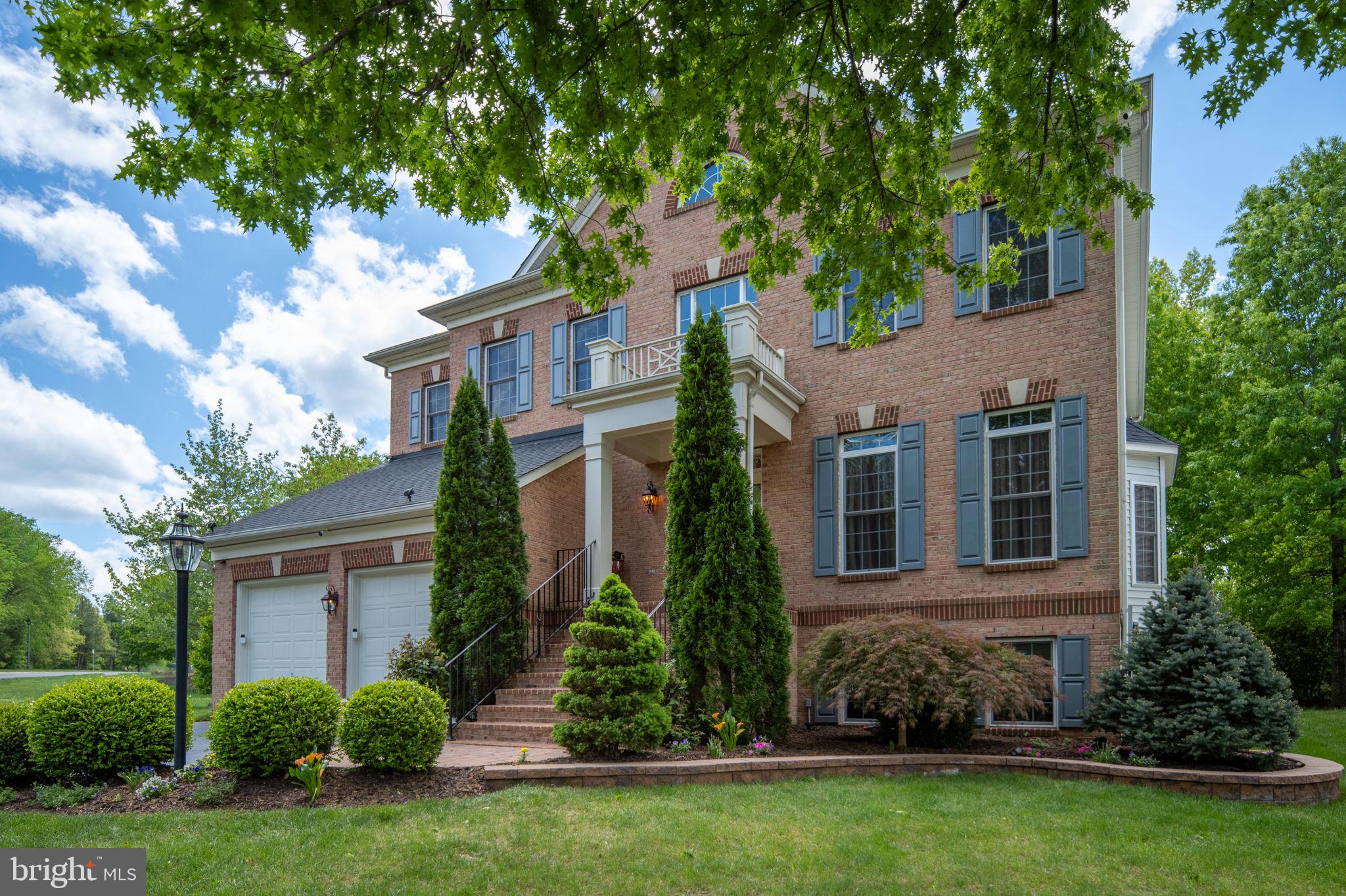 14541 Old Mill Road Centreville, VA 20121 - Photo 4 of 109 Elegant brick home with lush greenery.