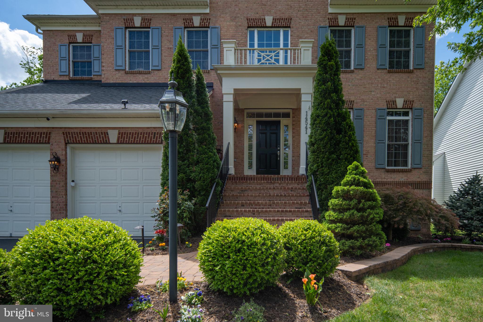 14541 Old Mill Road Centreville, VA 20121 - Photo 7 of 109 Charming brick facade with lush greenery.