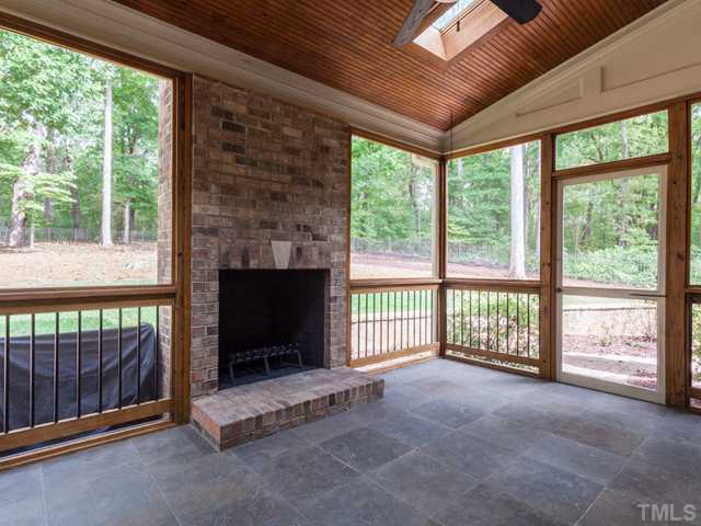 12816 River Dance Drive Raleigh, NC 27613 - Photo 24 of 25 Imagine the quality time you will spend on the screen porch. This special outdoor retreat offers a fireplace, tile flooring, and a spectacular view of the backyard. The screen porch leads to the paver stone patio.