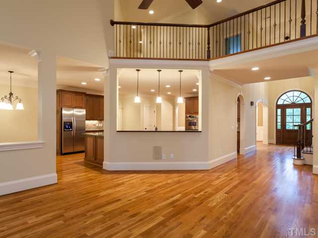 12816 River Dance Drive Raleigh, NC 27613 - Photo 9 of 25 This view illustrates the custom details of the home's interior features and the open flow of the main level. Each room is framed with heavy crown molding and deep baseboards. Distributed audio is another fine feature of this room.