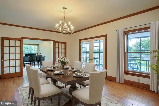 a kitchen with stainless steel appliances granite countertop a sink a stove and a wooden floors