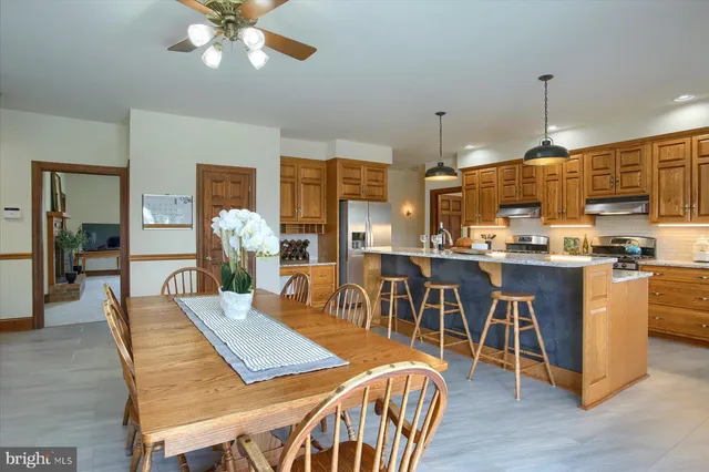 a bathroom with a granite countertop sink a toilet and mirror
