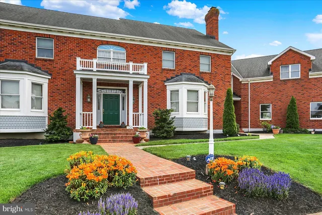 a view of entryway and hall with wooden floor and a front door