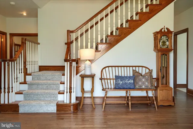 an empty room with windows and fireplace