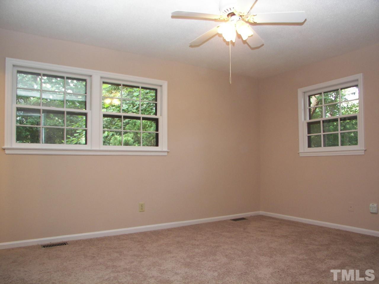 6729 Johnsdale Road Raleigh, NC 27615 - Photo 13 of 25 an empty room with a window and a fan