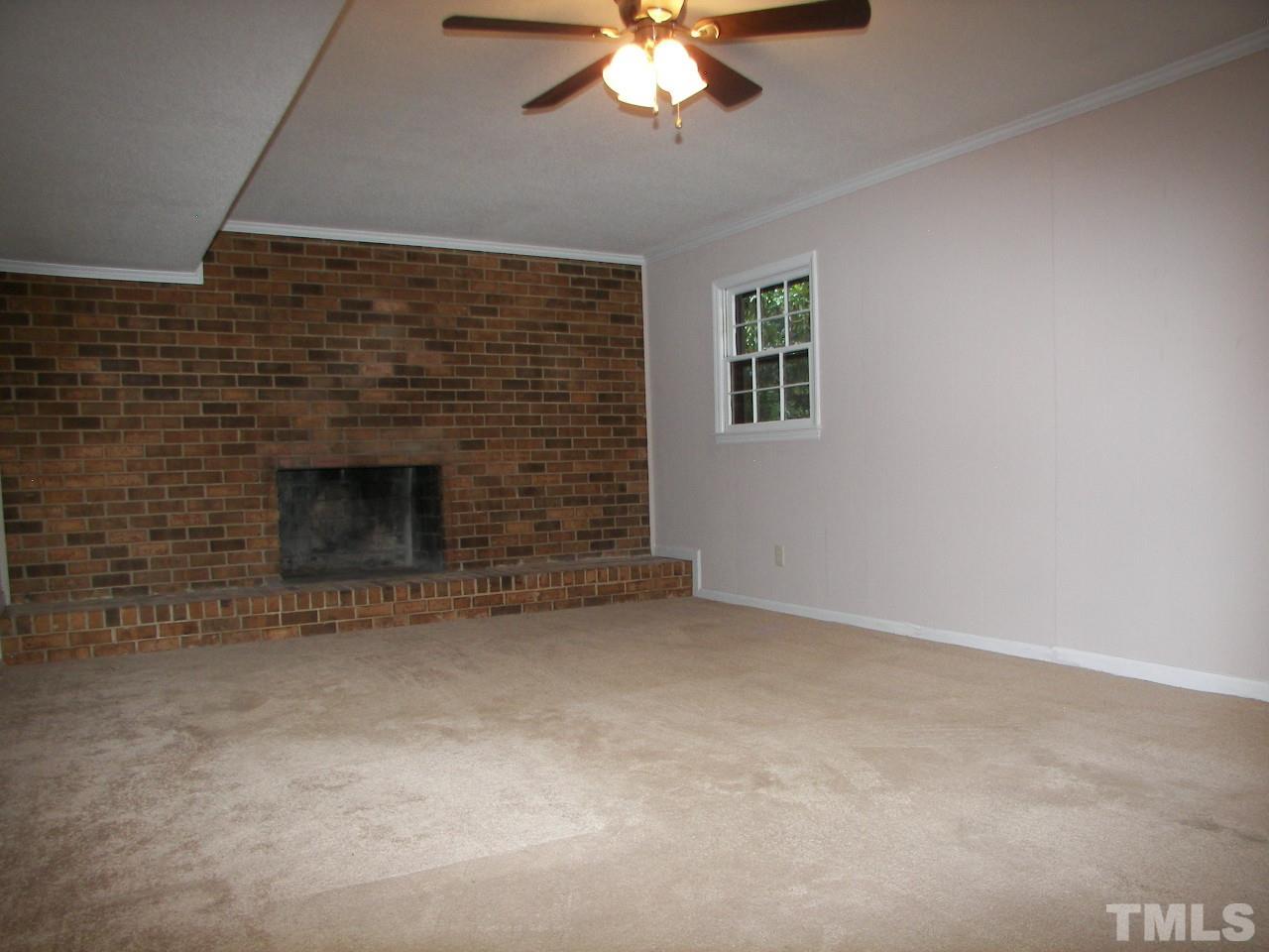 6729 Johnsdale Road Raleigh, NC 27615 - Photo 16 of 25 an empty room with a fireplace